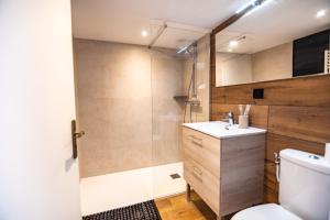 a bathroom with a toilet and a sink and a shower at Cristal Room in Rochefort