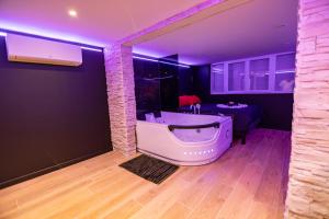 a bathroom with a large tub in a room at Cristal Room in Rochefort