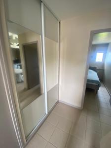 a room with a sliding glass door and a bedroom at Calme en vacances in Urrugne