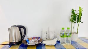 a table with a coffee maker and bottles of water at Blooming Hill Cabin Ella in Ella