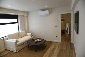 a living room with a white couch and a table at Amber Apartments in Jávea