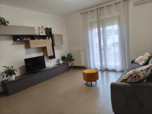 a living room with a couch and a tv at My Home Apartments in Matera