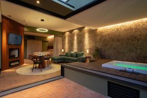 a living room with a jacuzzi tub in a room at Vila Chalés in Itu
