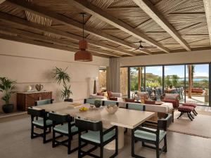 a dining room with a table and chairs at Six Senses AMAALA in Amala