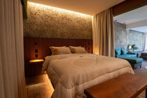 a bedroom with a large bed and a blue chair at Vila Chalés in Itu +14 photos