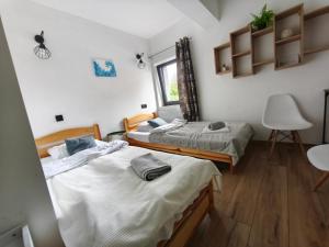 a bedroom with two beds and a window at Apartamenty RETRO FV in Koszalin +97 photos