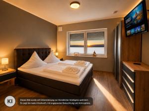 a hotel room with a bed and a television at Eastside Braunlage in Braunlage