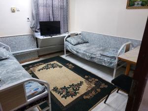 a living room with a couch and a table at Umid Hostel in Termiz +19 photos