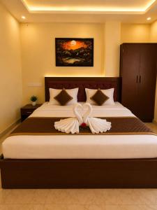 a bedroom with a bed with a bow on it at Hotel Sunny in Varanasi