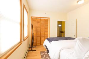a bedroom with a bed and a large window at 1 Bedroom Apartments Near Kendall Square in Cambridge