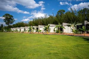 a building with a lawn in front of it at Vila Chalés in Itu
