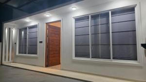a room with two windows and a door at The Harmony Mount Lavinia in Dehiwala