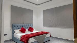 a bedroom with a bed with red pillows on it at The Harmony Mount Lavinia in Dehiwala