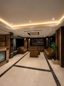 a large living room with couches and a fireplace at The Zinnia Castle- Dharamshala # Centrally Heated & Air Cooled # Premium Rooms # Lift # Bar # Terrace # Big Parking # Near market # Top Rated # Property of the year in Dharamshala