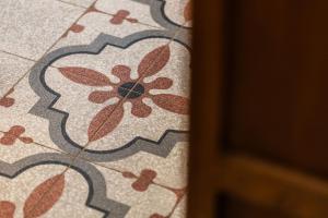 a close up of a tile floor with a flower pattern at TorripaCollection - Villa Livia - Bolsena Lake in Montefiascone