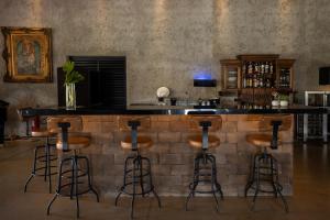 a bar in a room with stools at Vila Chalés in Itu