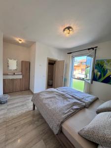 a bedroom with a large bed and a window at Terrazza sul Lago in Riva del Garda