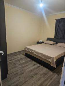 a bedroom with a bed and a light on the wall at NectaraVilla PooL in Ashtarak