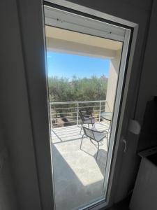 a sliding glass door with a view of a balcony at Rujovic 