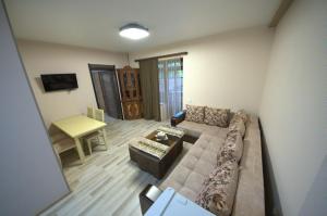 a living room with a couch and a table at Hotel Dilijan Old Center in Aghk'ilisa +11 photos