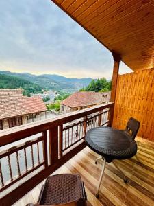 a table and chair on a balcony with a view at Hotel Dilijan Old Center in Aghk'ilisa