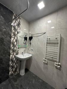 a bathroom with a sink and a shower at Hotel Dilijan Old Center in Aghk'ilisa
