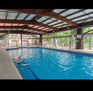 a person swimming in a large swimming pool at Apartamento nas Termas no Apart-hotel in Gravatal