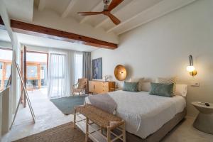 a bedroom with a bed with a ceiling fan at Boho Suites Denia in Denia