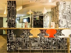 a bar with black and white graffiti on the wall at ibis Orleans Centre Gare in Orléans