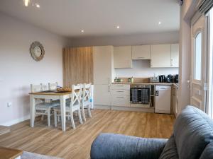 a kitchen and dining room with a table and chairs at Mountain View Cottages in Tralee