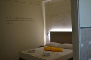 a bedroom with a bed with a sign on the wall at Sa Domo e tzia Caterina in Orgosolo +17 photos