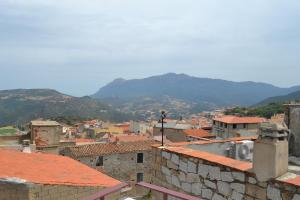 a view of a city with mountains in the background at Sa Domo e tzia Caterina in Orgosolo