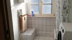 a small bathroom with a window and a toilet at Haus Lindheim in Altenstadt +10 photos