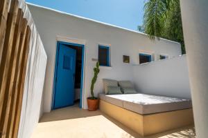a patio with a blue door and a cactus at Boho Suites Denia in Denia +37 photos