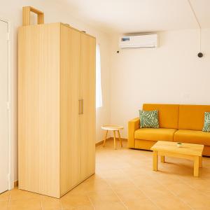 a large wooden cabinet in a living room with a couch at Océan serinity Santa Maria in Santa Maria