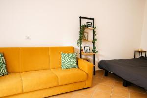 a living room with a yellow couch and a bed at Océan serinity Santa Maria in Santa Maria