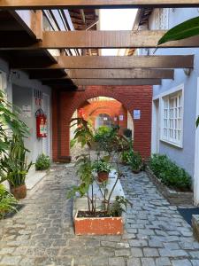 a building with an archway with plants in a courtyard at Apartamento em Condomínio - Centro de Búzios in Búzios