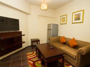 a living room with a couch and a tv at Porto Sharm Elshiekh Vacation Hotel in Sharm El Sheikh