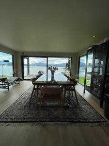 a dining room with a table and a view of the ocean at The Hidden Gem in Ålesund