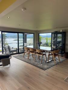 a dining room with a table and chairs and windows at The Hidden Gem in Ålesund