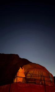 a person is standing inside of a dome tent at Luxury cMp in Al Karāmah