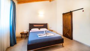 a bedroom with a bed with two towels on it at Villa Lagerta in Kayakoy +15 photos