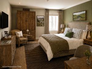a bedroom with a large bed and a living room at The Lister Arms in Malham