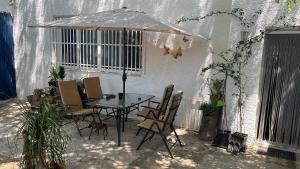 a table and chairs under an umbrella in a patio at Nirvana camp in Matola