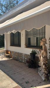 a building with a statue of a bear sitting on a bench at Nirvana camp in Matola