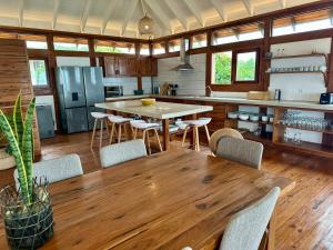 a large kitchen with a wooden table and chairs at Makana 7 in Ponta Mamoli