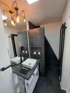 a bathroom with two sinks and a mirror at 4 Rest in a warm and comfortable loft in Coihaique +2 photos