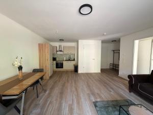 a living room with a table and a couch at FeWo Alissa in Nordrach +2 photos