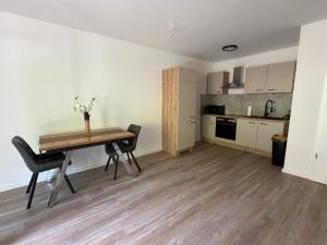 a kitchen and dining room with a table and chairs at FeWo Alissa in Nordrach