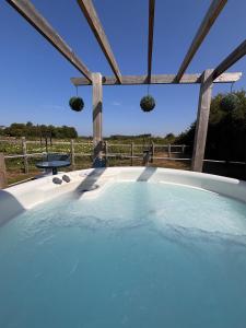 a hot tub with a view of a field at Rife Lodges in Arundel